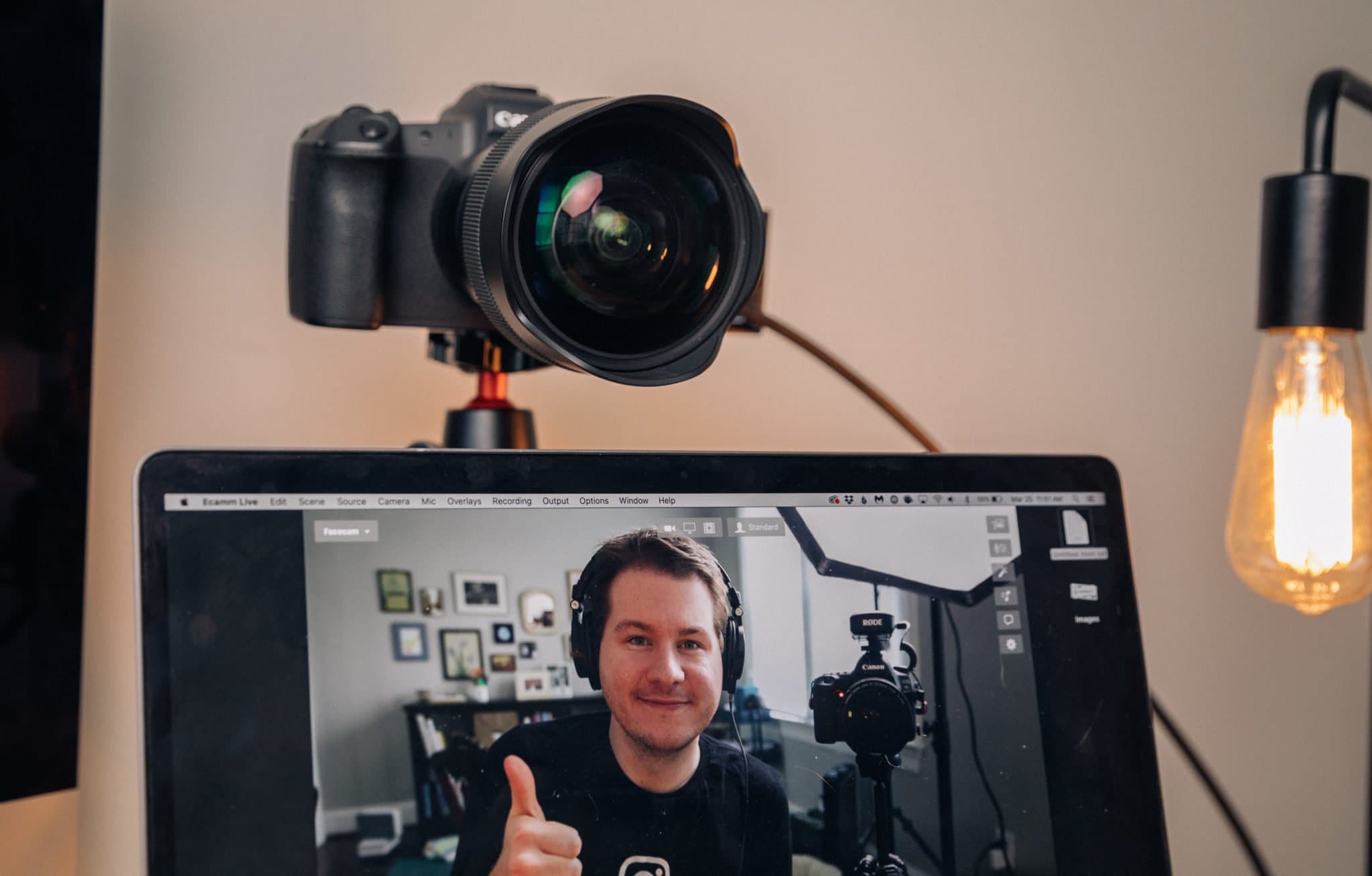 Andy Feliciotti using his camera as a webcam and thumbing up