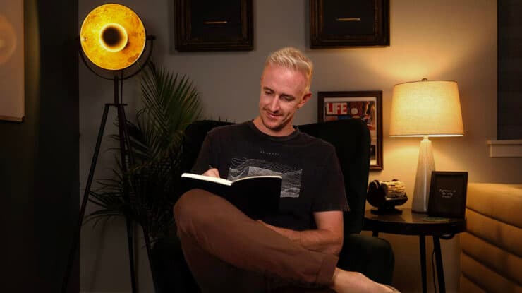 Ryan Robinson Blogger Writing in Journal on Sofa Chair